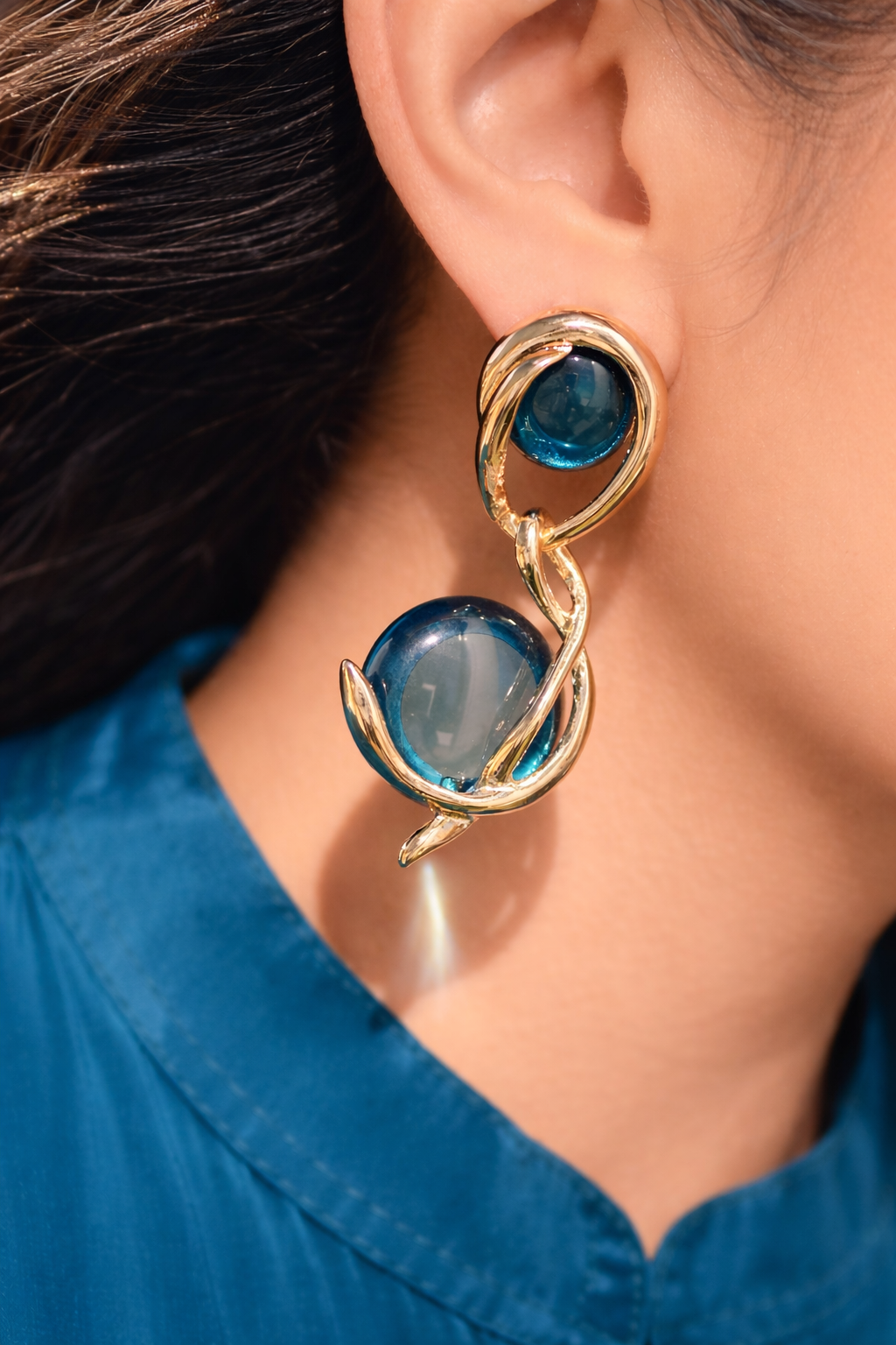 Teal glass and metal abstract design earrings.